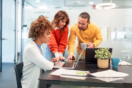 Marketing team working together on a project in modern office.