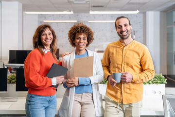 Happy businesspeople smiling together in modern office