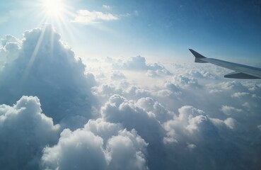 Aerial photo from airplane window at high altitude. Sunny sky with layer of misty haze, distant clouds. Wing of plane. Flight above clouds. Travel. Atmosphere environment.