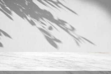 Obraz premium Marble table with tree shadow drop on white wall background for mockup product display