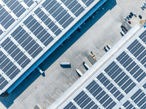 Aerial View of Factory with Solar Panels and Transport Trucks
