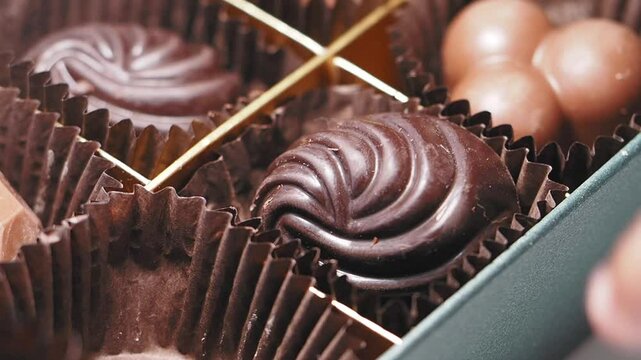 hand pick chocolates in a gift box
