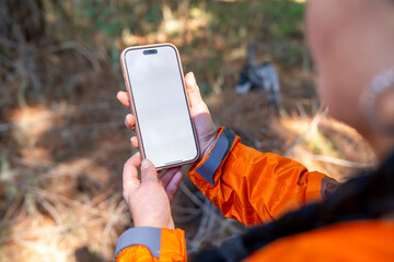 Hiker using blank smartphone screen