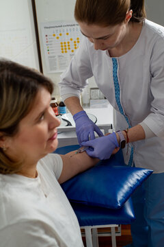 Nurse taking blood from a patient's vein