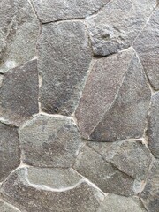 A house fence made from natural stones