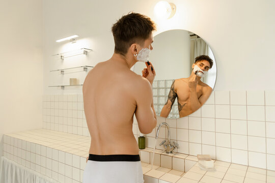 Shaving in the morning in front of the mirror 