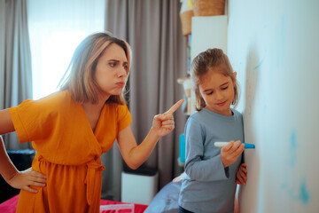 Mom Scolds Her Little Girl Who Writes on the Walls at Home. Unhappy mother feeling annoyed by the...