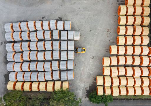 Aerial view of organized cable spools in a factory yard.
