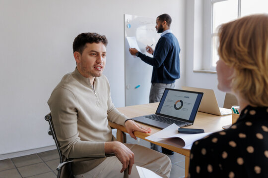 Formal business team discussing strategy during office meeting