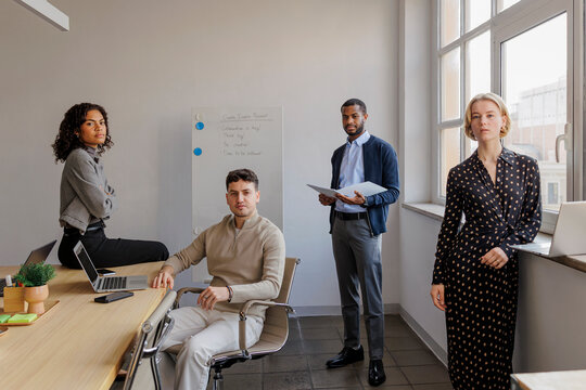 Startup formal business team posing in modern office after a meeting
