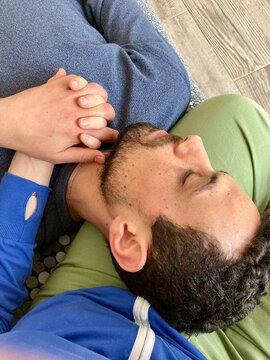 UGC of man holding woman's hand while resting head on her lap