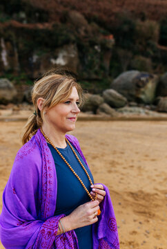 Woman holding mala beads