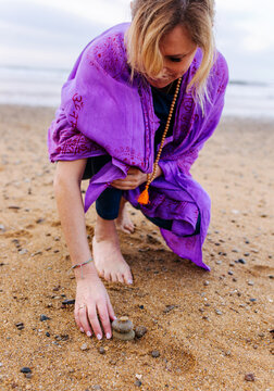 Woman creating stone balance