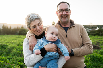 Grandparents holding their grandson
