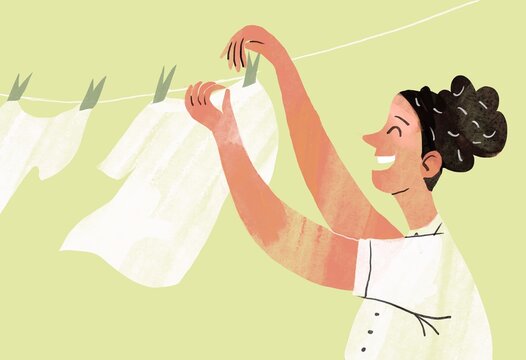Woman hangs washed clean white laundry
