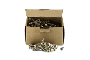 A cardboard box overflows with a pile of shiny metal screws against a clean white background.