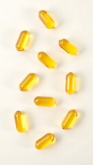 Vitamin D Softgel Capsules on White Background – Top View, Golden Translucent Pills for Health and Immunity
