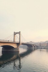 Serene Suspension Bridge Spanning Calm River Waters at Dawn