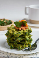Healthy eating. Spinach and fish waffles for breakfast.