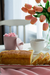 Breakfast. On the table is a fresh cake cut into pieces and aromatic coffee.