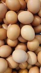Close up of randomly stacked chicken eggs sold at the market as a background.
