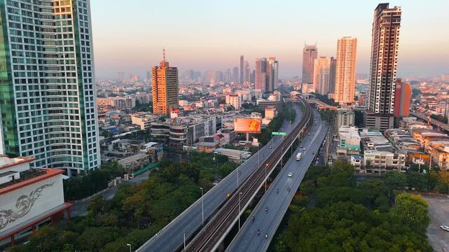 Krung Thon Buri Road and skytrain over Chao Phraya river at sunset. Transport infrastructure of Bangkok city