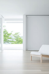 Modern minimalist living room featuring spacious design with natural light and greenery