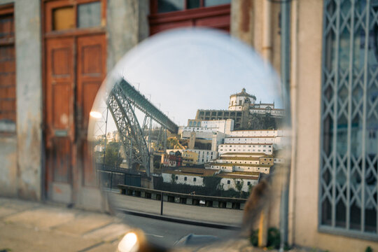 Historic cityscape reflected in round mirror