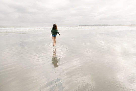 young woman running on beach