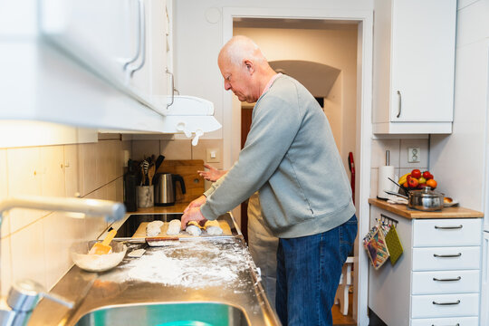 Senior couple baking fresh bread together in the kitchen