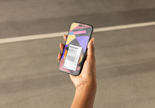 Smartphone Screen Held in Hand Outdoors. PSD mockup