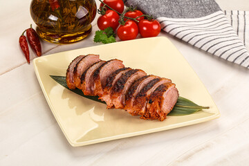 Sliced duck breast baked with cherry