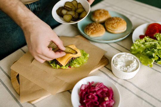 Putting Pickles To Burger