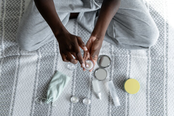 Young woman hands using skincare products