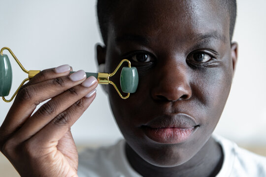 Closeup of a woman using jade roller