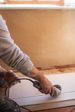 bricklayer cutting tiles