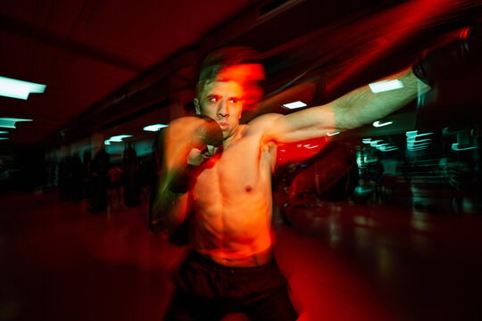 Intense boxing training session in a lively gym environment