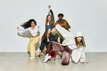 Group of dancers performing stylish poses in studio setting