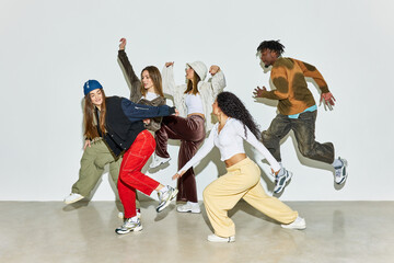 Dynamic group of dancers in contemporary urban fashion performin