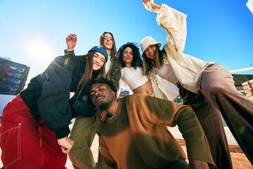 Friends enjoying a sunny day on a rooftop in an urban setting
