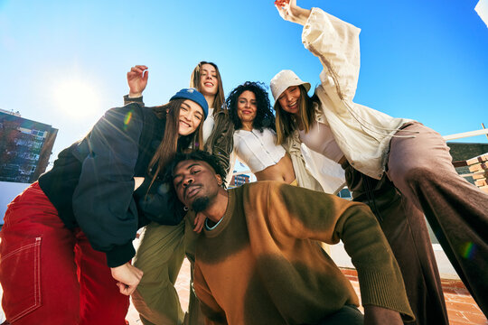 Friends enjoying a sunny day on a rooftop in an urban setting