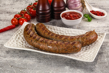 Grilled beef sausages with sauce