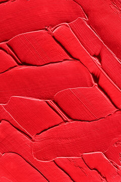 Abstract texture of bright red lipstick layered in strokes