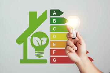 Energy-saving homes, energy efficiency concepts, eco-friendly home improvements, cost savings, low-energy eco-friendly homes, green handshake. © Sansert