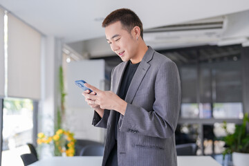 Handsome confident asian secretary man clever smart professional businessman  talking on phone  in office