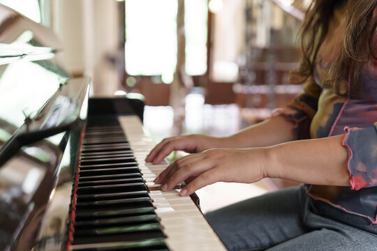 Girl learn to play piano. woman hand playing piano .