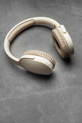 Wireless headphones resting on gray surface