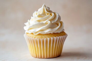 A single cupcake with white frosting sits on a soft background