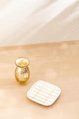 Copy space warm lighting background.Blank wallpaper with minimalist vase.Light and Shadow. Space for text.Backdrop.Studio photography.Sunshine. Chic style. Vase isolated on wooden. Home decor. Clean.