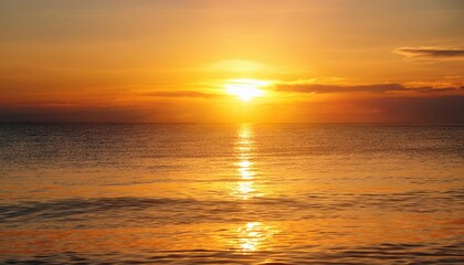 Naklejka premium Breathtaking golden sunrise over calm ocean waters with shimmering reflections symbolizing peace